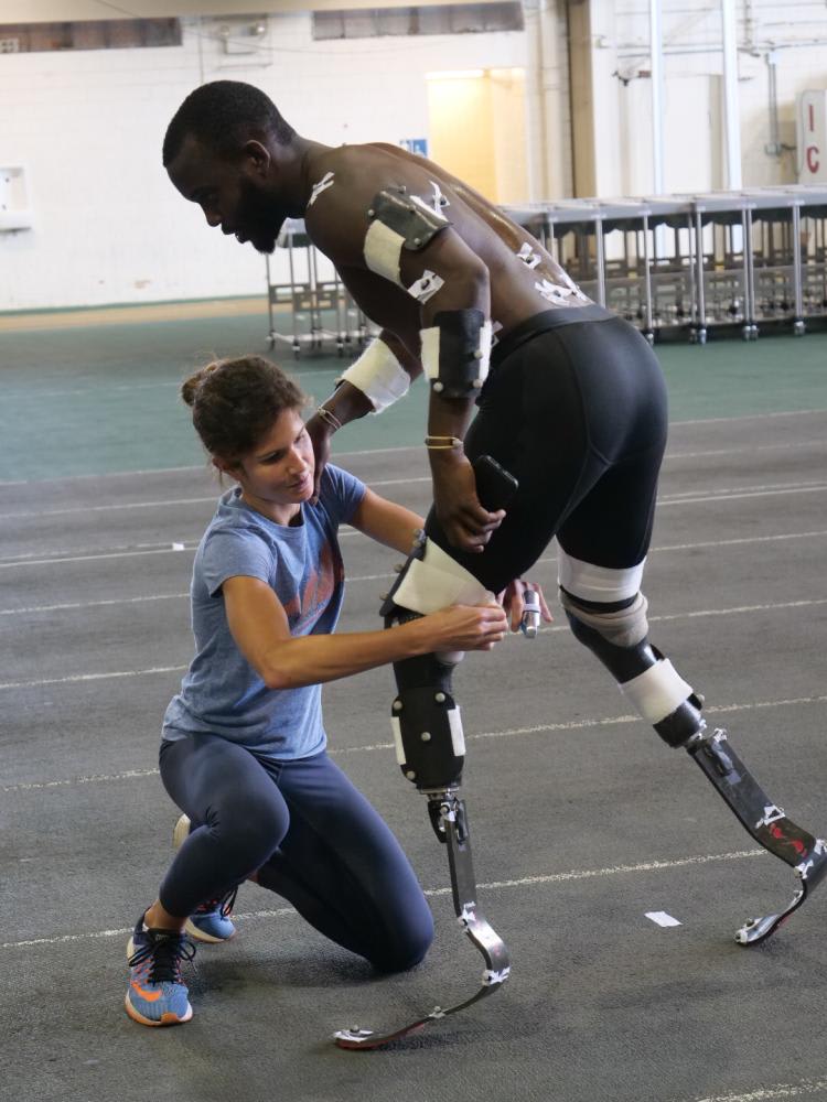 Protetyk dopasowuje protezę biegową zawodnikowi — trening z biomechanikiem